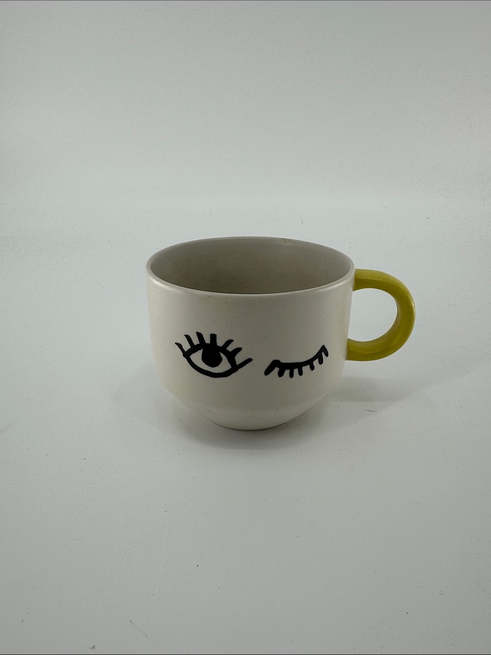 Starbucks White Ceramic Mug with Yellow Handle and Eye Motif